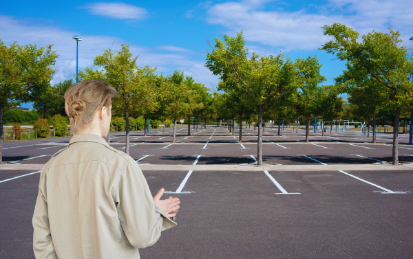A groomer standing in an empty parking space where their van was stolen.